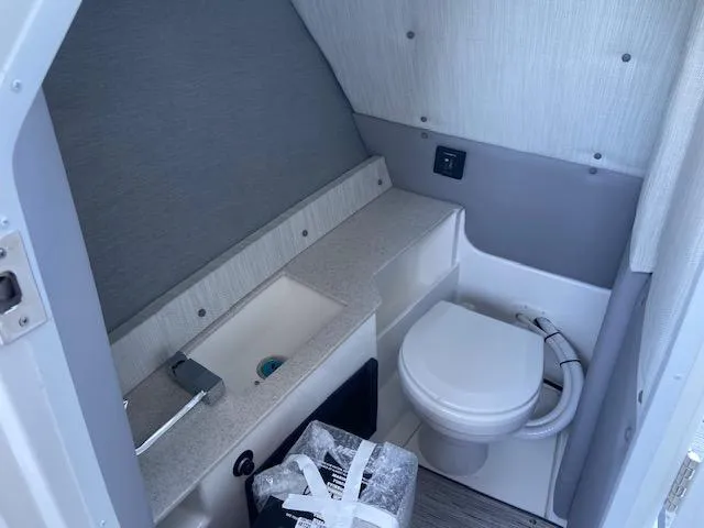 Slide: The Image of 2024 Cobalt R8 boat bathroom with toilet and sink. - 8