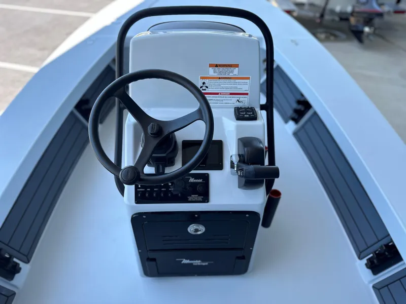 Slide: The Image of 2024 Maverick 18 HPX-V boat console with steering wheel and controls. - 14