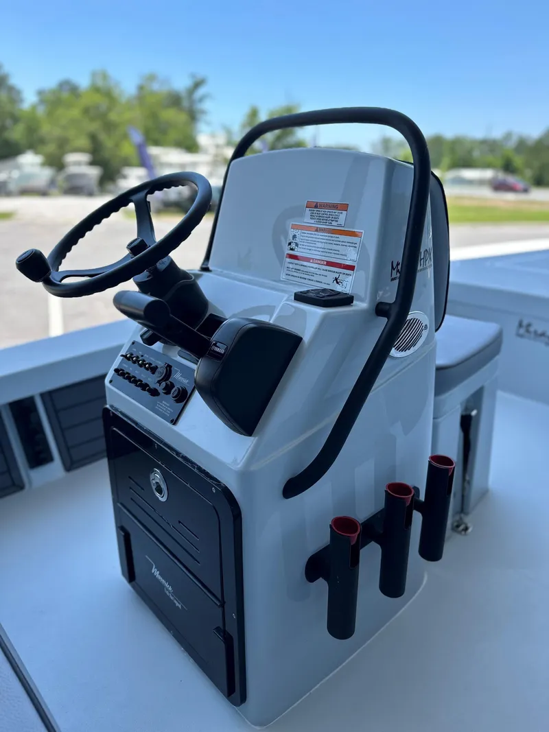 Slide: The Image of 2024 Maverick 18 HPX-V boat console with steering wheel and rod holders. - 5