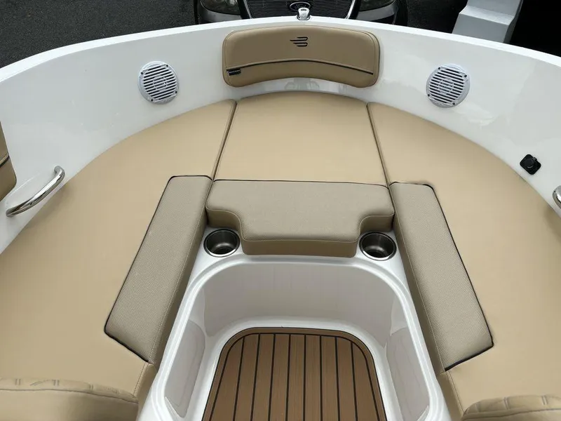 Slide: The Image of 2024 Bayliner VR5 Bowrider boat with tan cushioned seating and cup holders. - 10