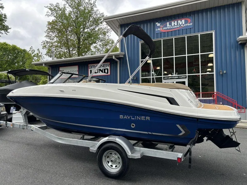 Slide: The Image of 2024 Bayliner VR5 Bowrider boat on a trailer outside a dealership. - 3