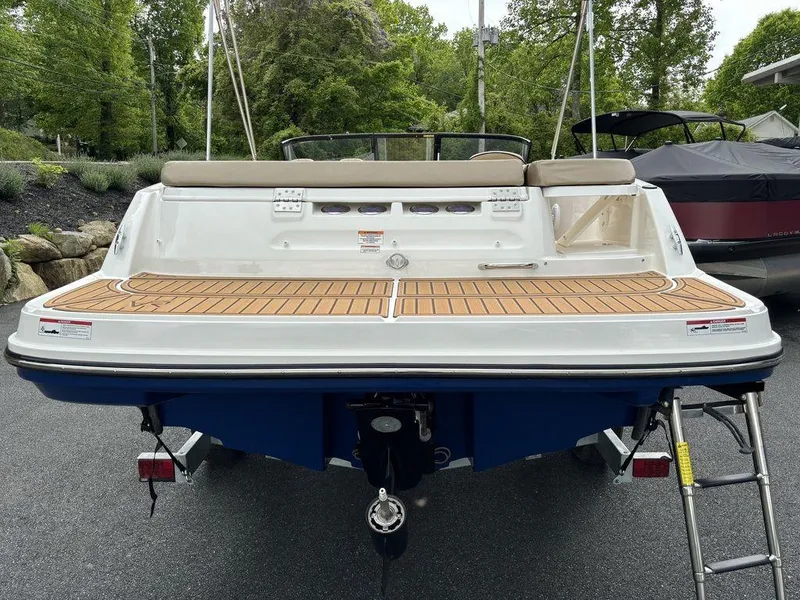 Slide: The Image of 2024 Bayliner VR5 Bowrider boat with teak swim platform, rear view. - 4