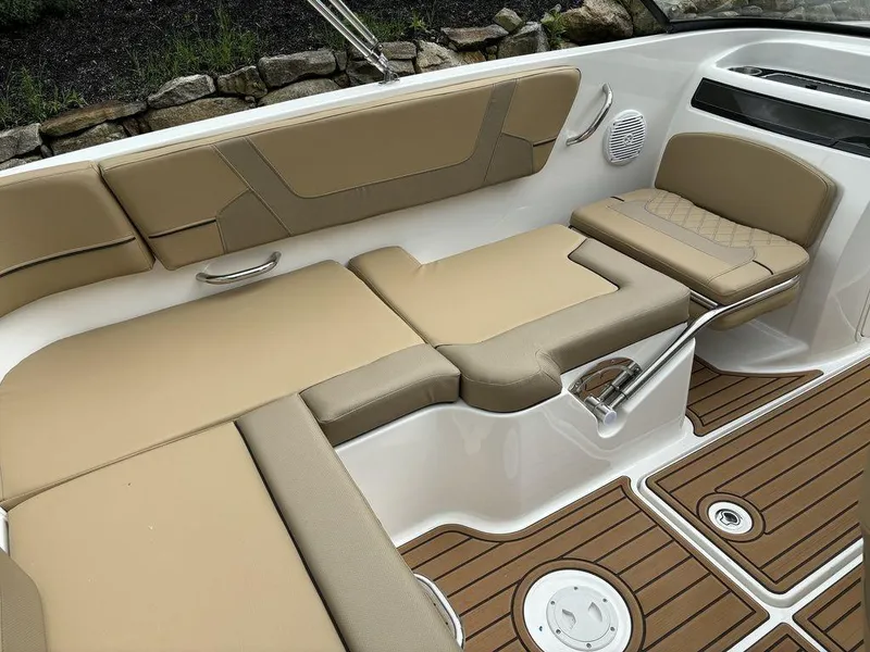 Slide: The Image of 2024 Bayliner VR5 Bowrider interior with tan seating and teak-style flooring. - 7