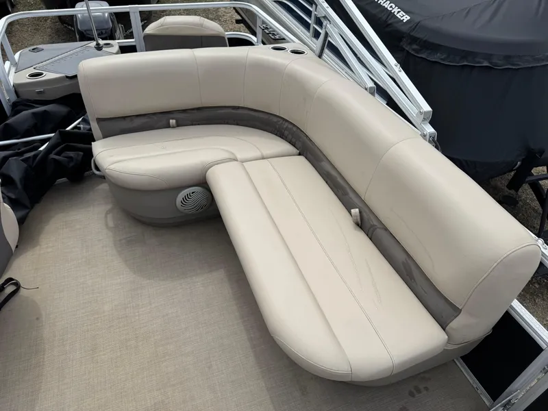 Slide: The Image of 2020 Sun Tracker Bass Buggy 18 DLX pontoon boat with beige seating and cup holders. - 11