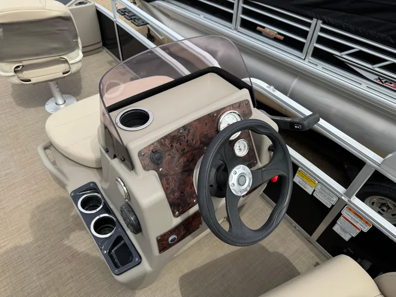 Slide: The Image of 2020 Sun Tracker Bass Buggy 18 DLX pontoon boat steering console with cup holders. - 13