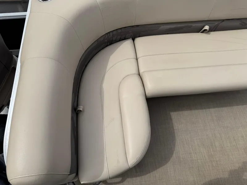 Slide: The Image of 2020 Sun Tracker Bass Buggy 18 DLX boat seating, beige upholstery, corner view. - 18