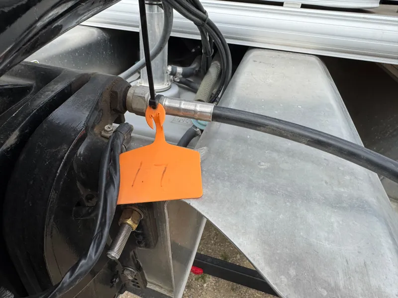 Slide: The Image of Close-up of 2020 Sun Tracker Bass Buggy 18 DLX boat engine components with orange tag. - 6