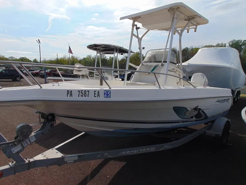 Slide: The Image of 2002 Aquasport 190 Osprey boat on trailer in parking lot. - 3