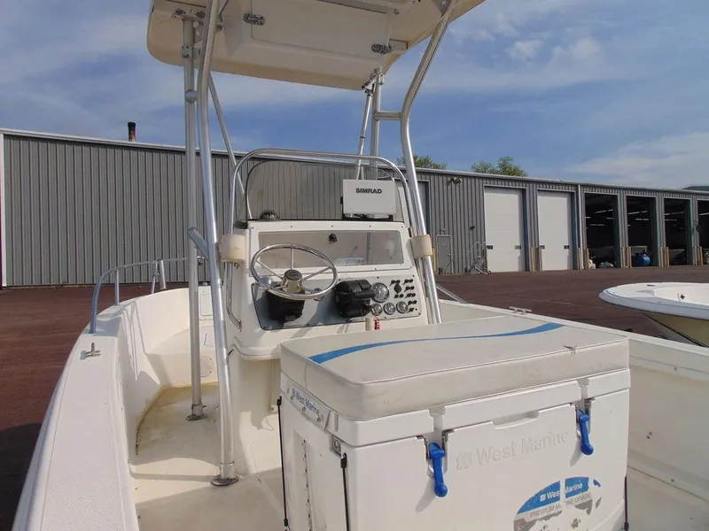 Slide: The Image of 2002 Aquasport 190 Osprey boat with center console and T-top in a marina. - 4