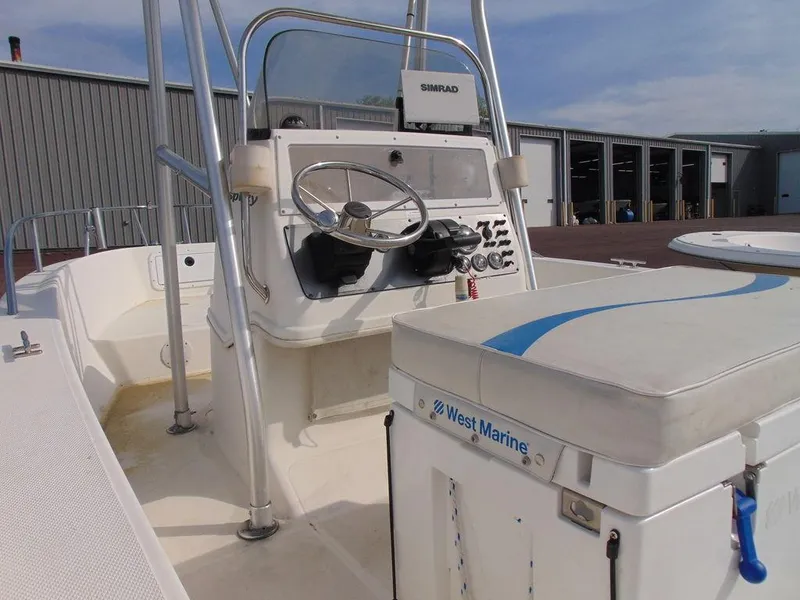 Slide: The Image of 2002 Aquasport 190 Osprey boat interior with steering console and seating. - 5
