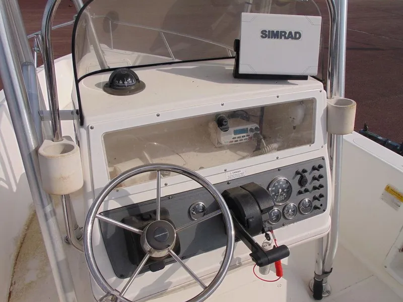 Slide: The Image of 2002 Aquasport 190 Osprey boat console with steering wheel and Simrad navigation system. - 6