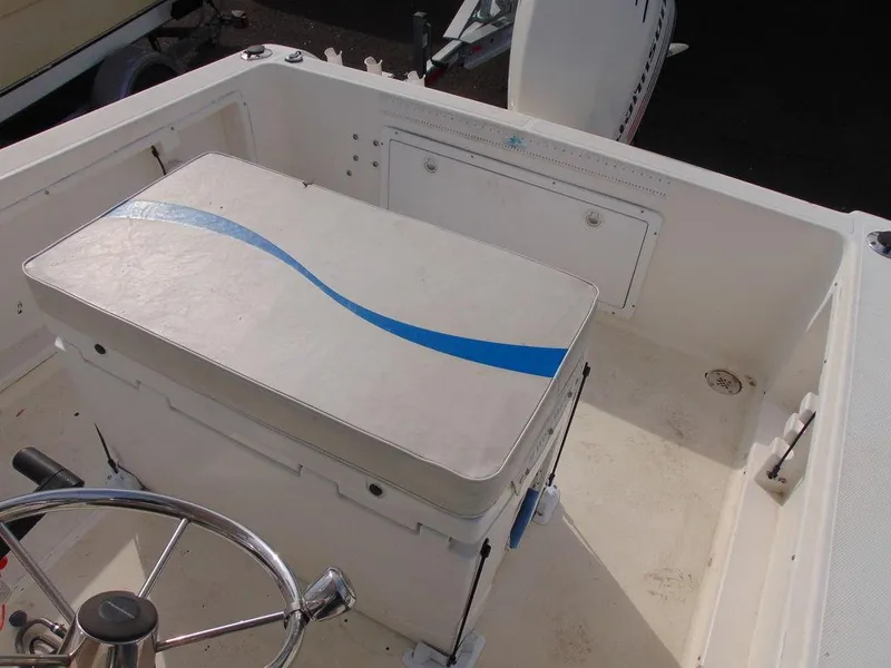 Slide: The Image of 2002 Aquasport 190 Osprey boat interior with cushioned seating and steering wheel. - 8