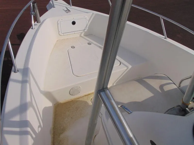 Slide: The Image of 2002 Aquasport 190 Osprey boat interior with storage compartments and railing. - 9