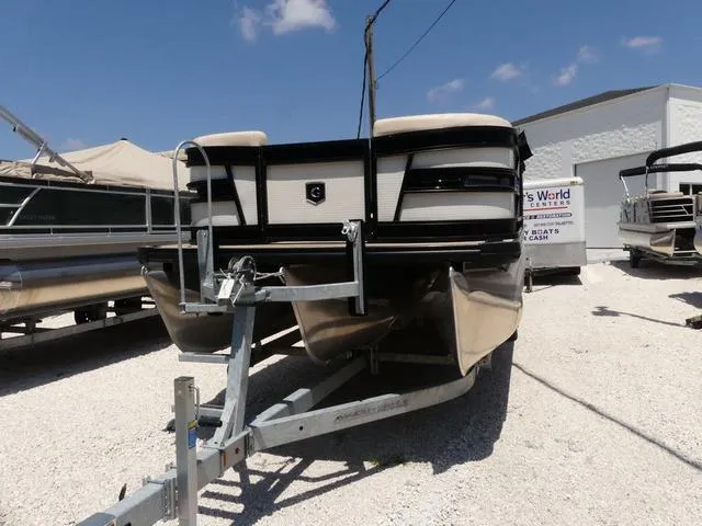 Slide: The Image of 2023 AquaPatio AquaPatio 255 SBC pontoon boat on a trailer in a boatyard. - 3