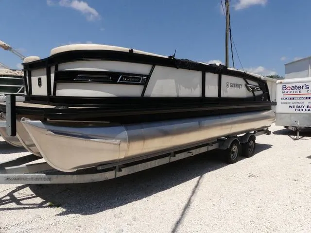 Slide: The Image of 2023 AquaPatio 255 SBC pontoon boat on a trailer in a marina. - 4