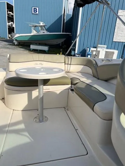 Slide: The Image of 2005 Sea Ray 240 Sundeck interior with seating and table. - 15