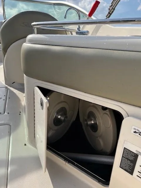 Slide: The Image of 2005 Sea Ray 240 Sundeck storage compartment with cooler and stereo system. - 18