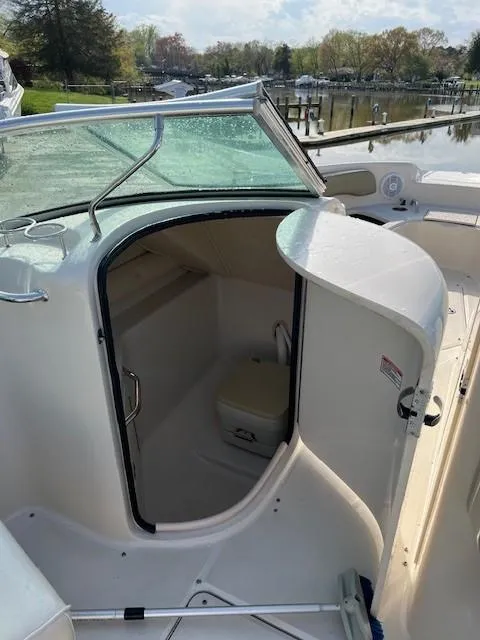 Slide: The Image of 2005 Sea Ray 240 Sundeck boat interior with seating and table. - 19