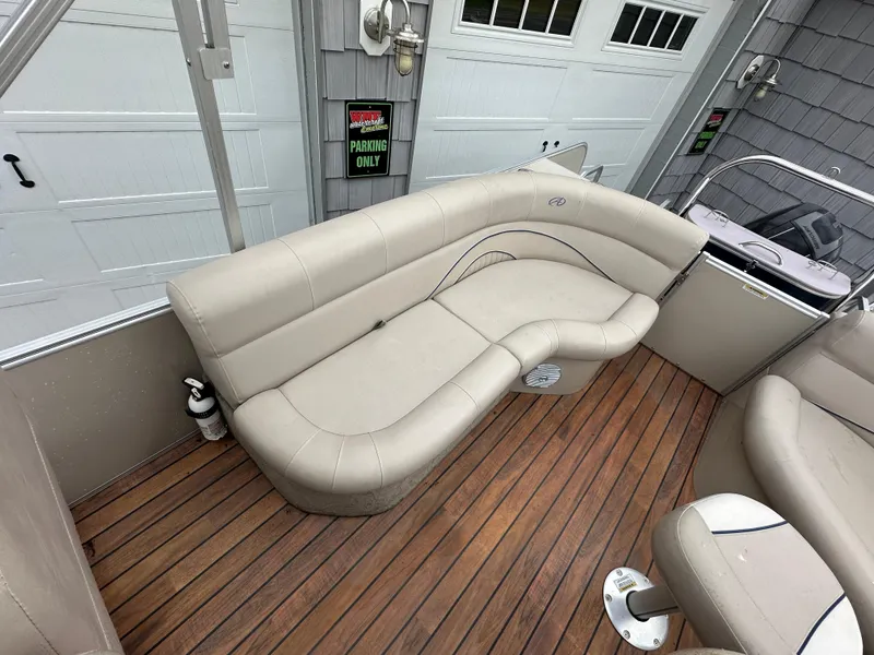 Slide: The Image of 2014 Avalon 2585 Catalina Bar / ENT Tri Toon High Performance boat with beige seating and wooden deck. - 17