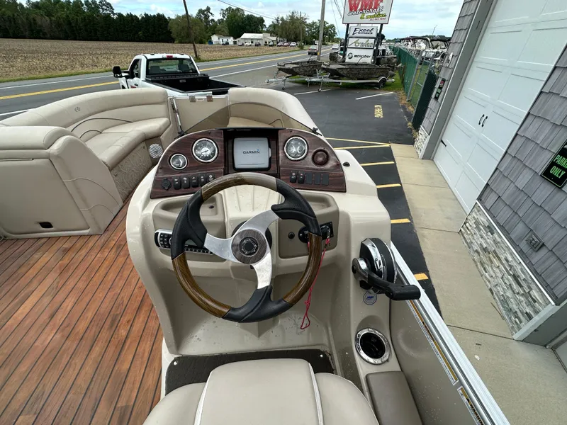 Slide: The Image of 2014 Avalon 2585 Catalina Bar / ENT Tri Toon High Performance boat dashboard and steering wheel. - 23