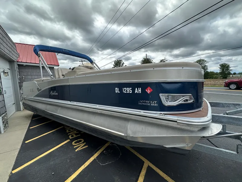 Slide: The Image of 2014 Avalon 2585 Catalina Bar / ENT Tri Toon High Performance boat in parking lot. - 9