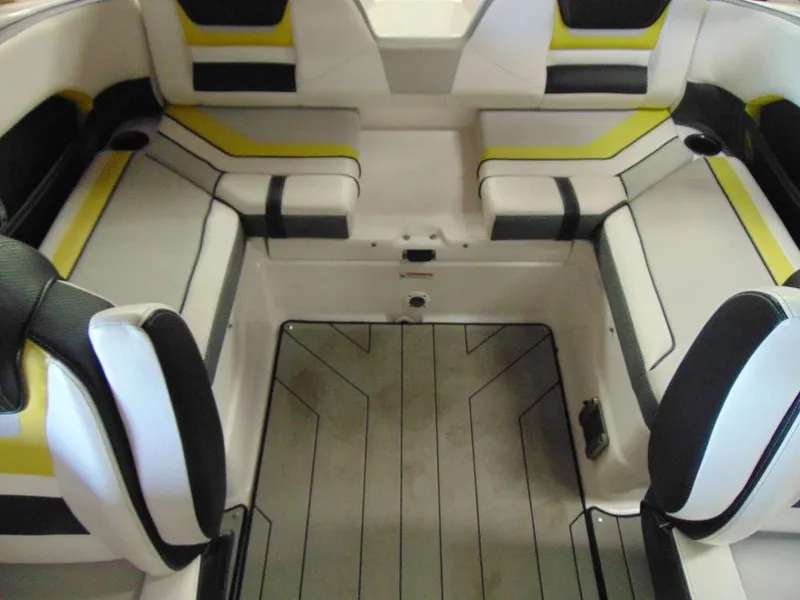 Slide: The Image of 2020 Yamaha Boats 212X interior seating area with modern design and yellow accents. - 13