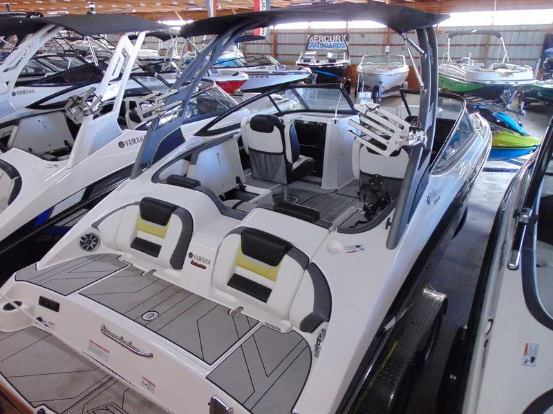 Slide: The Image of 2020 Yamaha Boats 212X in showroom, sleek design, spacious seating, and modern features. - 2