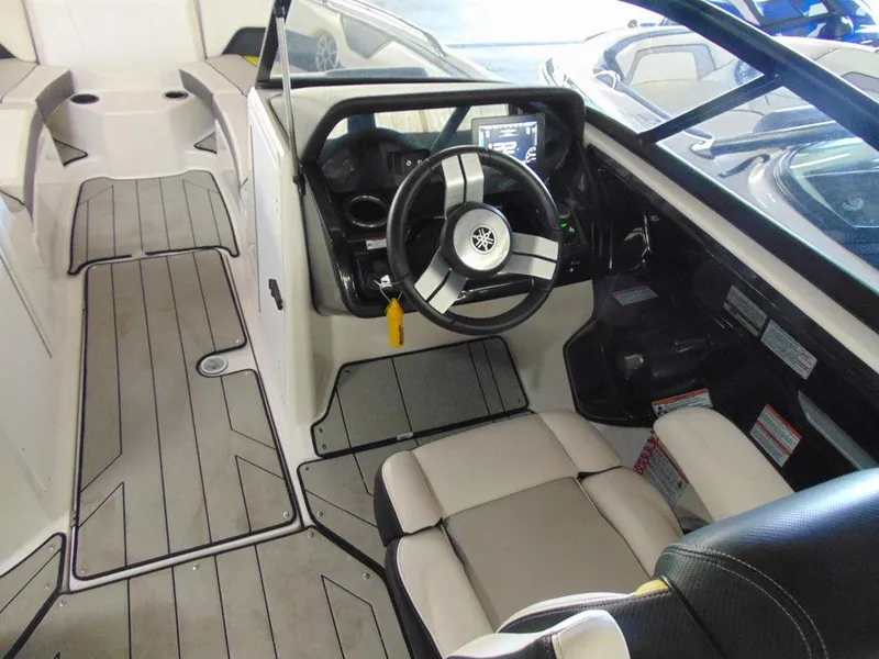 Slide: The Image of 2020 Yamaha Boats 212X interior cockpit with steering wheel and seating. - 8