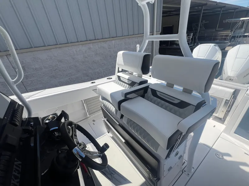 Slide: The Image of 2024 Blackfin 272 CC boat interior with dual helm seats and steering console. - 12