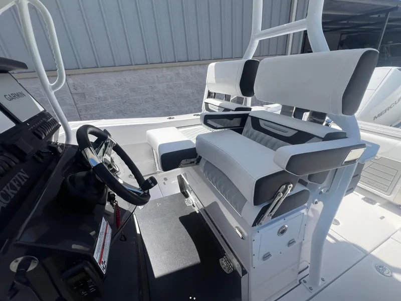 Slide: The Image of 2024 Blackfin 272 CC boat interior with dual helm seats and steering wheel. - 13