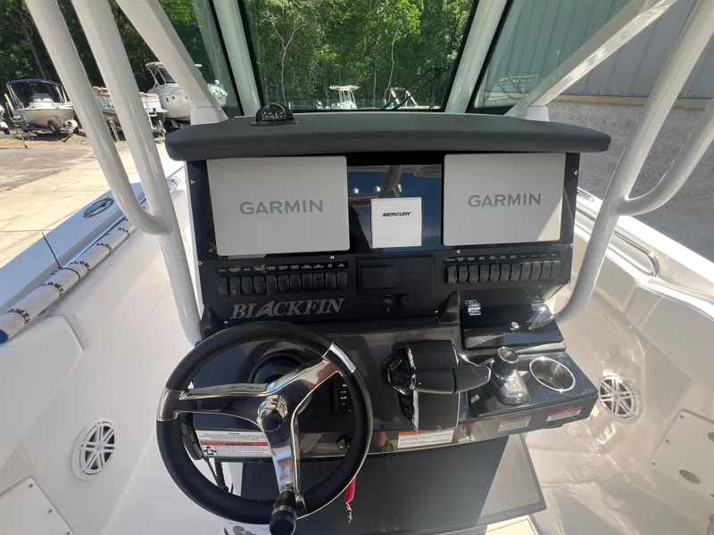 Slide: The Image of 2024 Blackfin 272 CC boat helm with dual Garmin displays and advanced controls. - 14