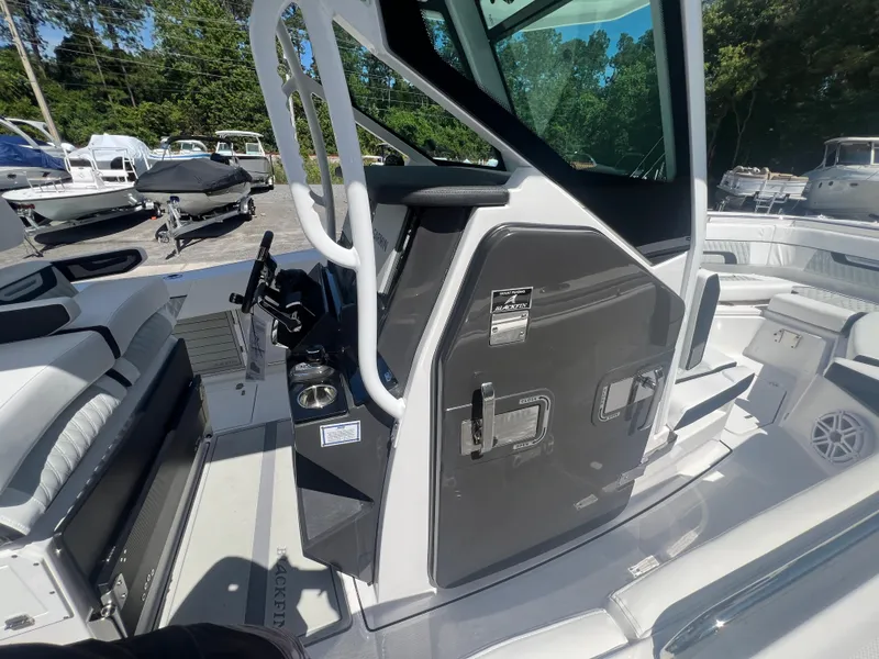 Slide: The Image of 2024 Blackfin 272 CC boat interior with helm station and seating. - 16