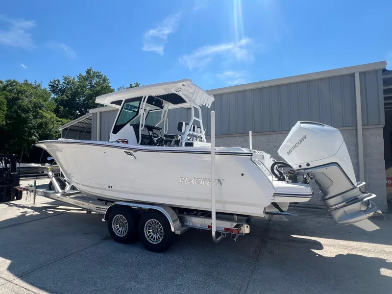 Slide: The Image of 2024 Blackfin 272 CC boat on trailer with twin Mercury outboard engines. - 2