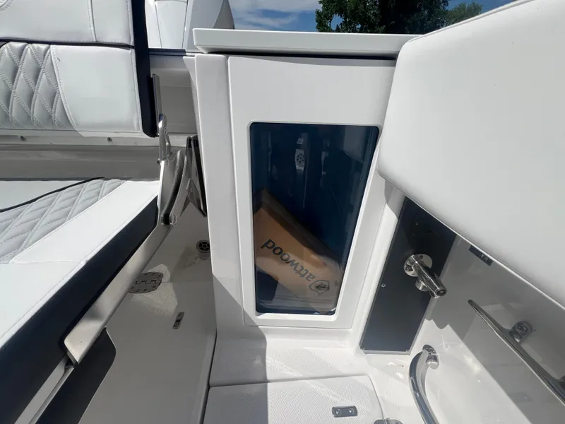 Slide: The Image of 2024 Blackfin 272 CC boat interior with storage compartment and seating. - 20