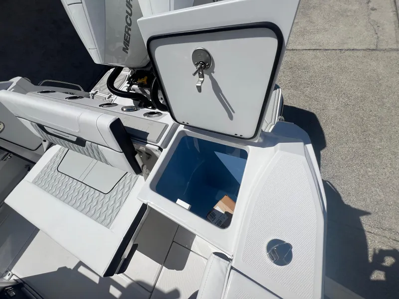 Slide: The Image of 2024 Blackfin 272 CC boat with open storage compartment and Mercury engine. - 21
