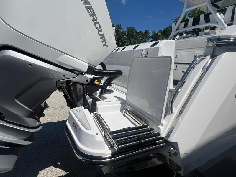 Slide: The Image of 2024 Blackfin 272 CC boat with Mercury outboard engine and swim ladder. - 23