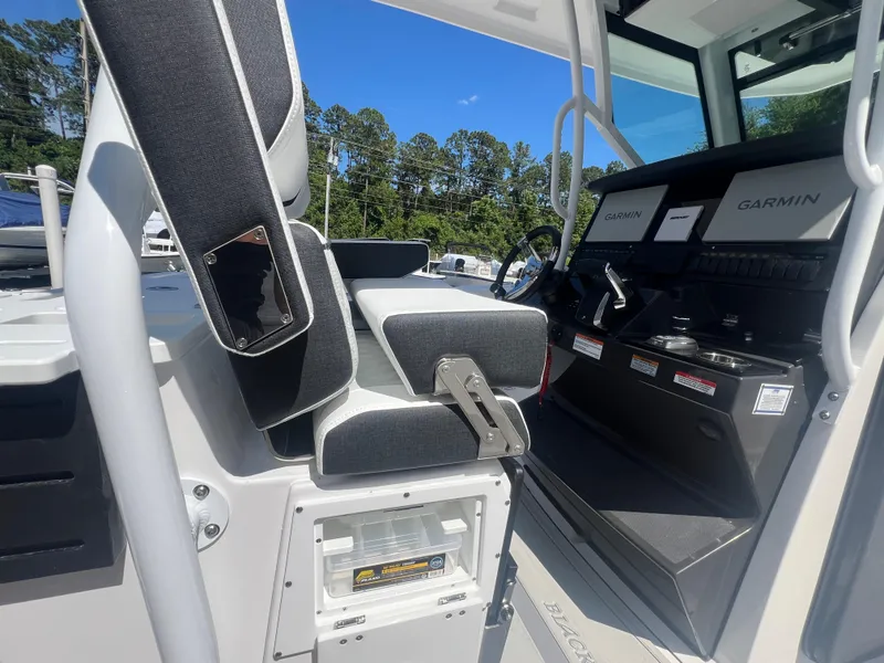 Slide: The Image of 2024 Blackfin 272 CC boat interior with Garmin navigation system and seating. - 26