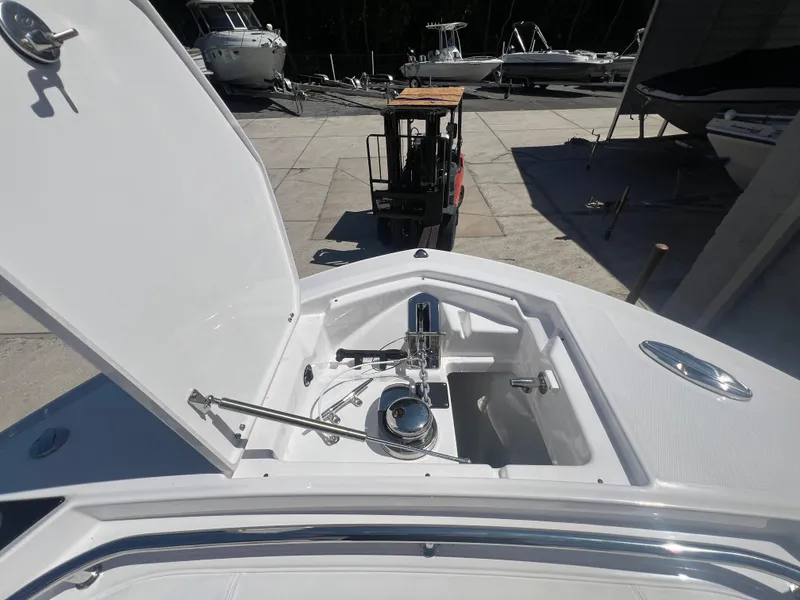 Slide: The Image of 2024 Blackfin 272 CC boat anchor compartment with open hatch. - 37