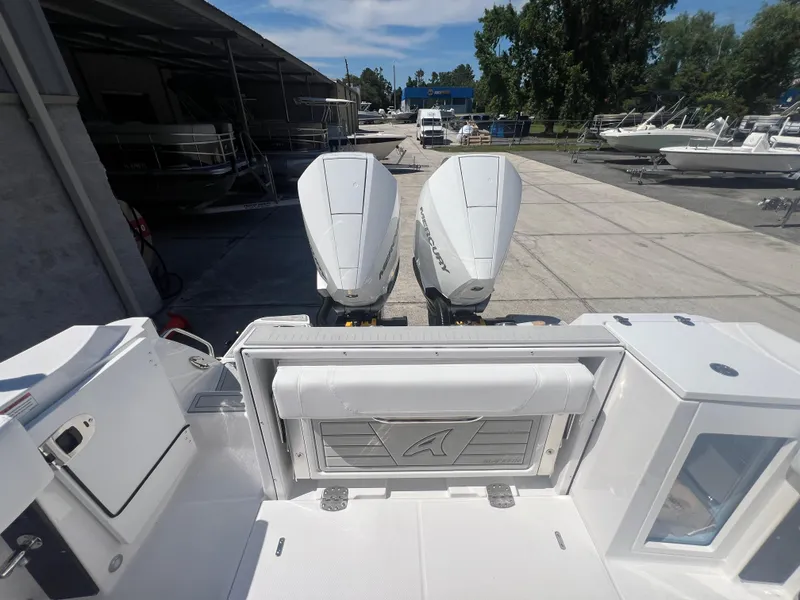 Slide: The Image of 2024 Blackfin 272 CC boat with dual outboard engines at a marina. - 4