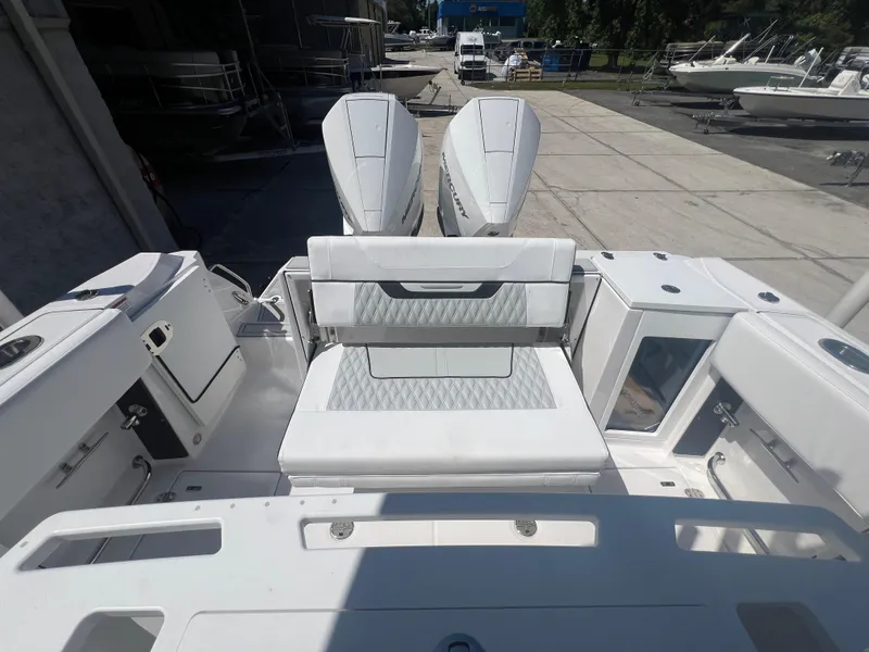 Slide: The Image of 2024 Blackfin 272 CC boat with dual outboard engines, rear seating, and storage compartments. - 5