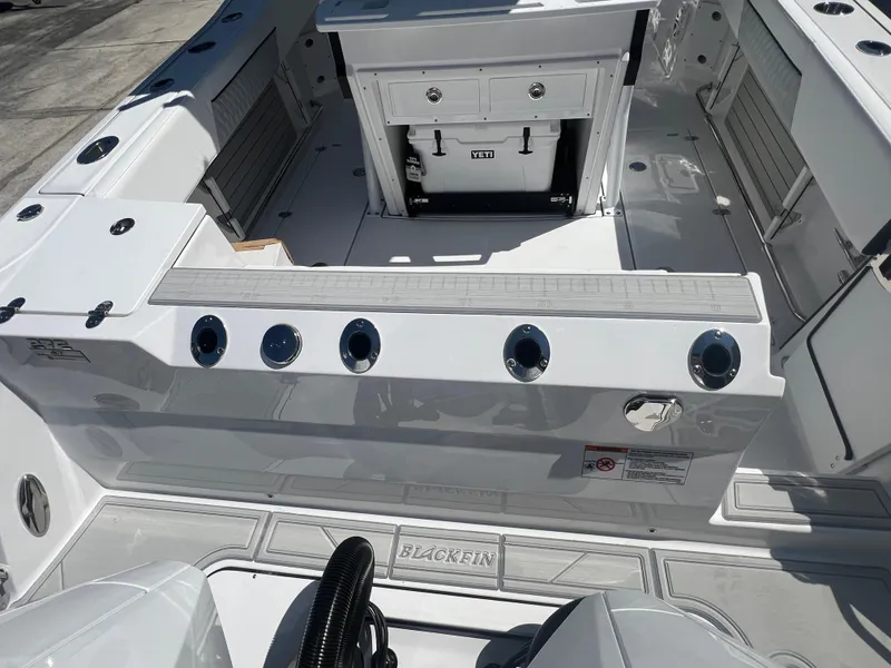Slide: The Image of 2024 Blackfin 272 CC boat interior with rod holders and storage compartments. - 6