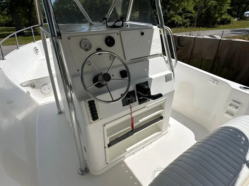 Slide: The Image of 2001 Pro Sports 2200 CC Blue Water boat console with steering wheel and controls. - 10