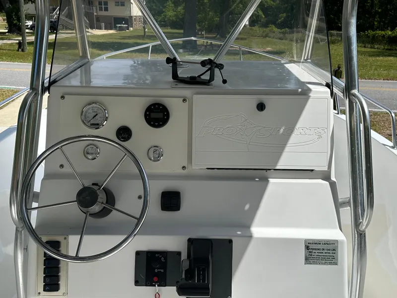 Slide: The Image of 2001 Pro Sports 2200 CC Blue Water boat console with steering wheel and gauges. - 6