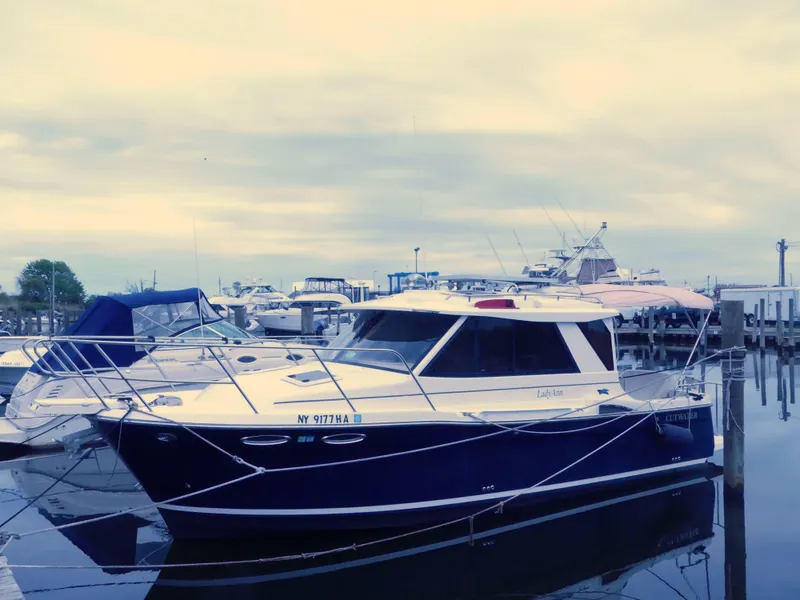 Slide: The Image of 2014 Cutwater C 26 boat docked at a marina. - 1