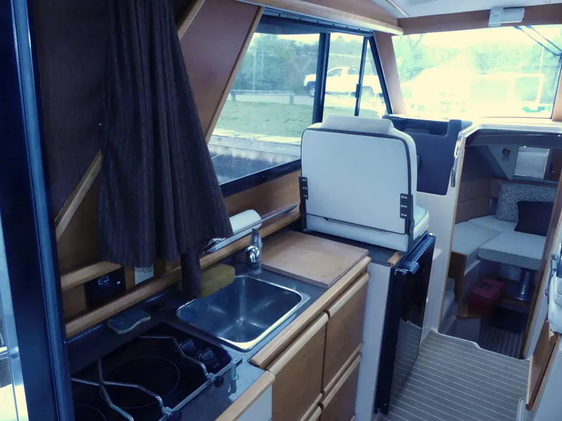 Slide: The Image of Interior of 2014 Cutwater C 26 boat with kitchen and seating area. - 14