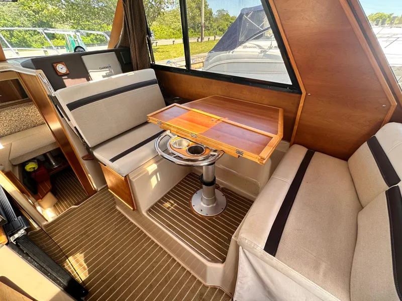 Slide: The Image of Interior of 2014 Cutwater C 26 boat with dining area and wooden table. - 21