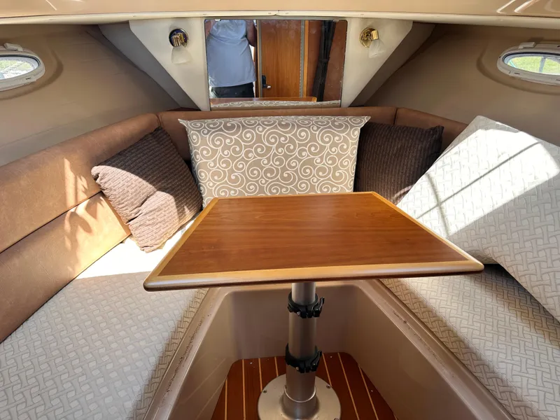 Slide: The Image of 2014 Cutwater C 26 cabin interior with dining table and cushioned seating. - 27