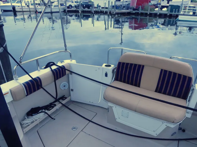 Slide: The Image of 2014 Cutwater C 26 boat interior with seating at a marina. - 6