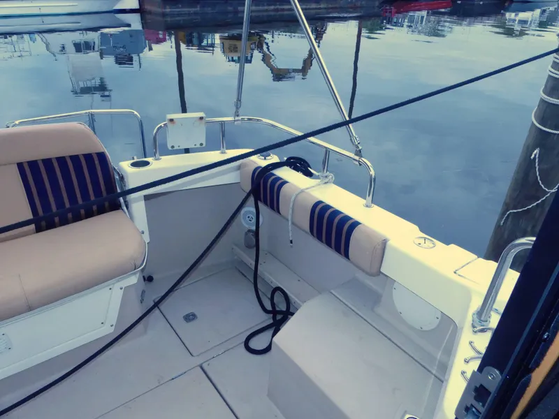 Slide: The Image of 2014 Cutwater C 26 boat interior with seating and docked at marina. - 7