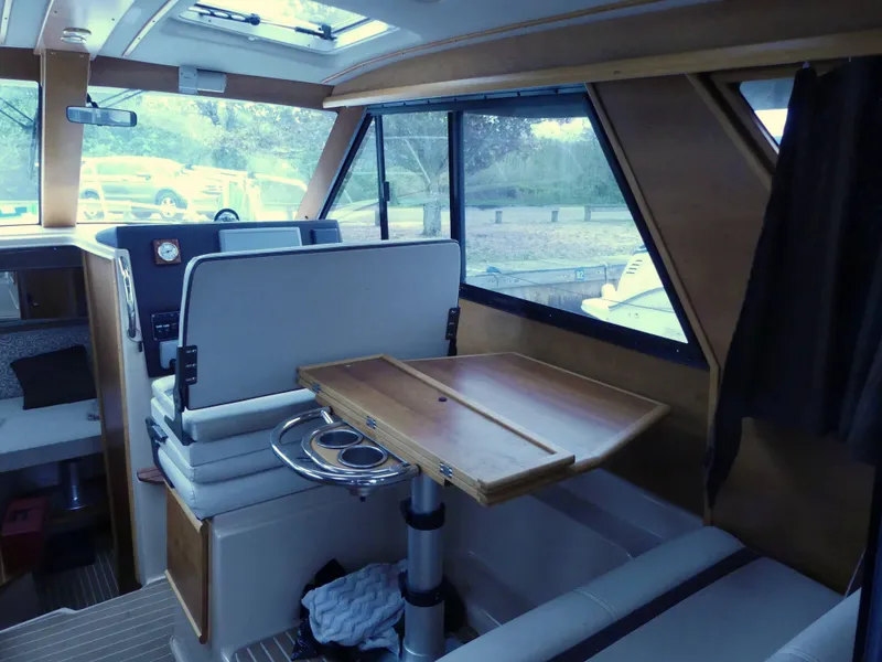 Slide: The Image of Interior of 2014 Cutwater C 26 boat with dining table and seating area. - 9